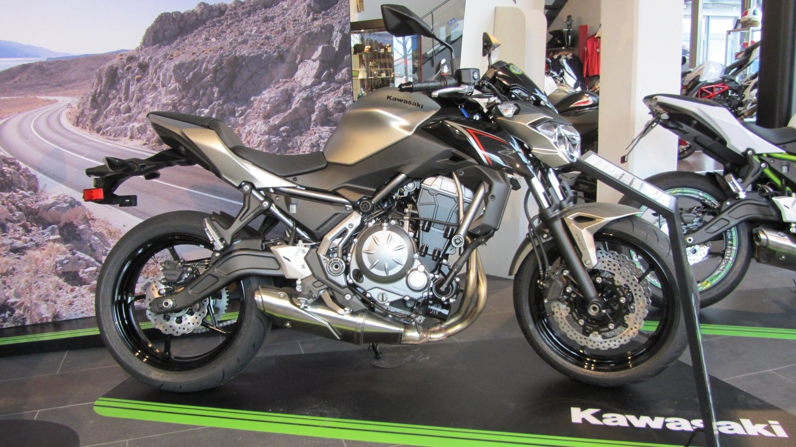 Side profile of a 2017 Kawasaki Z650 naked bike in metallic flat raw titanium and spark black